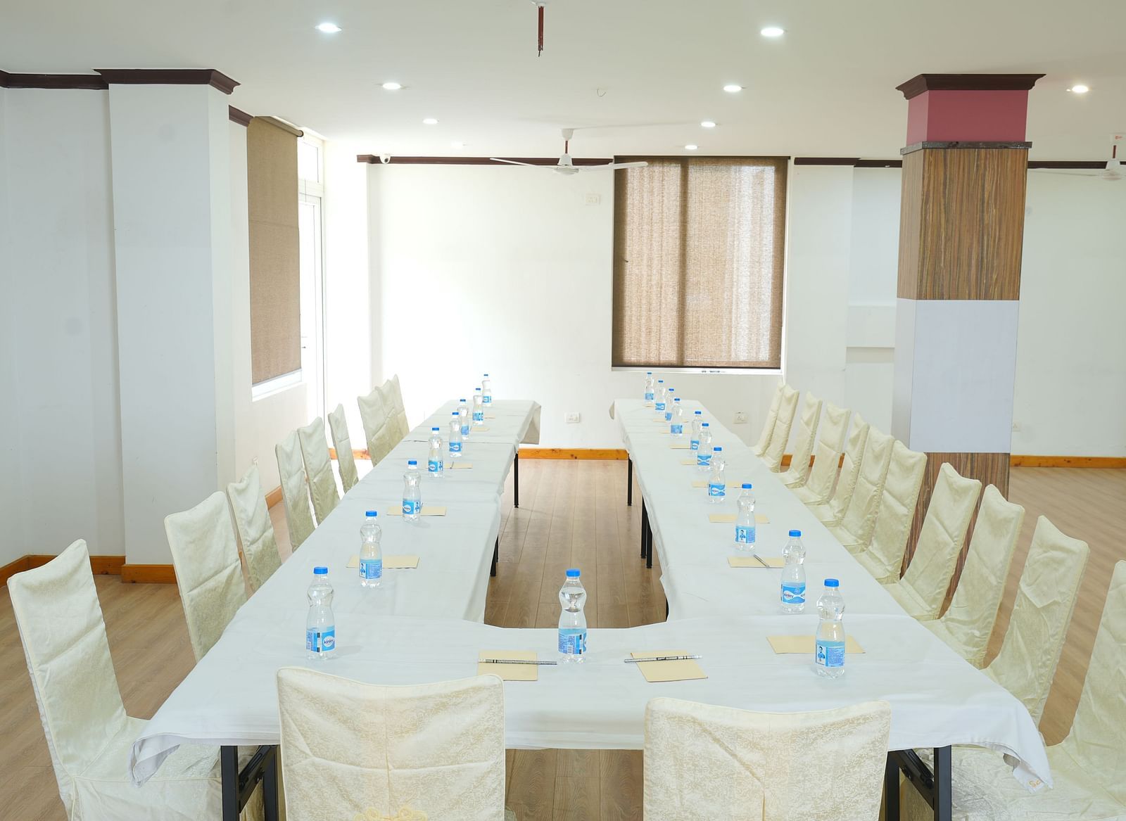 Image of the conference room featuring a large table and several chairs around it | DLS Hotel Shiva Sanctuary and Spa